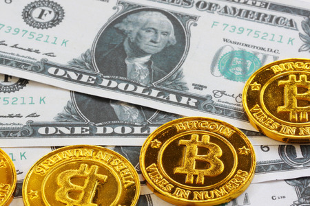 A bit coin is placed on bank notes background for business concepts and have copy space for you.の写真素材
