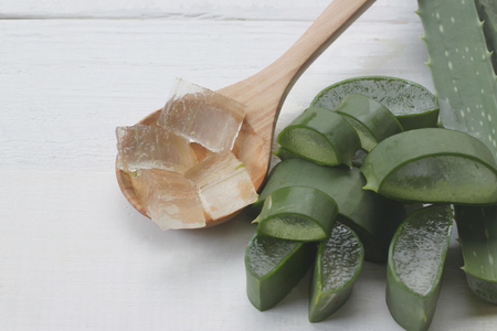 Slice Aloe vera is in a wooden spoon placed on a white wooden floor and have copy space for your work.の写真素材