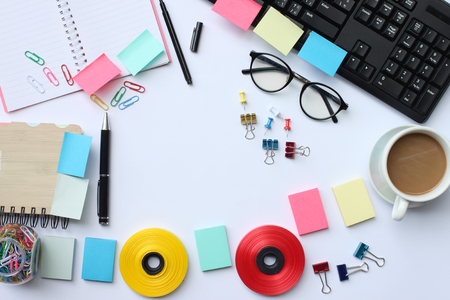 Notebook,pen,keyboard, coffee mug and accessories placed on a white desk In the office and have copy space the concept in your work.の写真素材