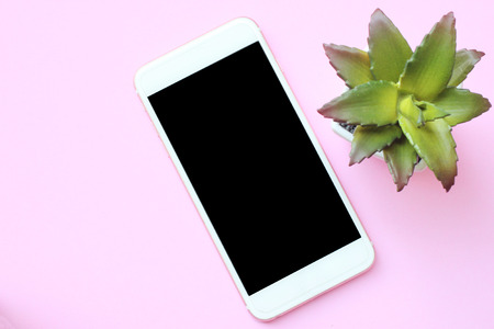 Business concept smartphones and flower pots place on the pink floor. Top view for design in your work.の写真素材