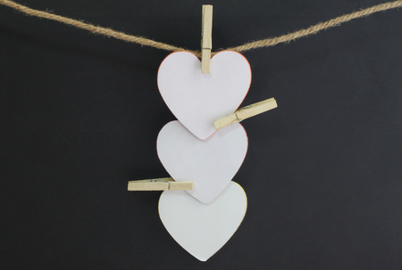 Paper heart blank on the rope with black background for your design.の写真素材