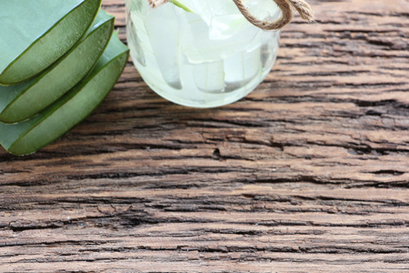Fresh aloe vera leaves and glass of aloe vera juice on wooden background and have copy space.の写真素材