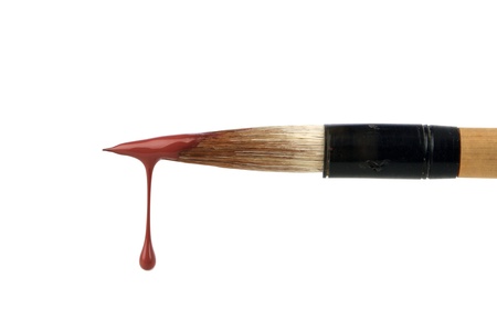 brush with red paint dropの写真素材