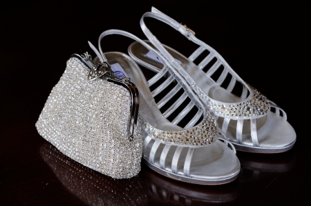 Brides silver shoes and shiny handbagの写真素材