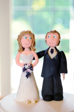 Bride and groom wedding decoration on top of cakeの写真素材