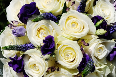 Brides white rose and purple flower closeup on wedding dayの写真素材