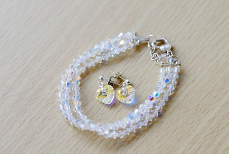 Closeup of brides earings and bracelet showing sparkly detail of heart shapes on wedding dayの写真素材