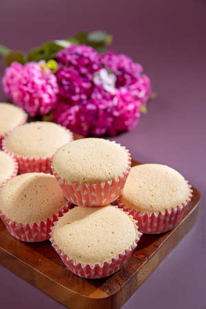 Ancient egg cakes in paper cup with purple background - stock photo