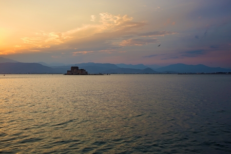 Sunset over Bourtzi castle in Nafplio, Greece.
