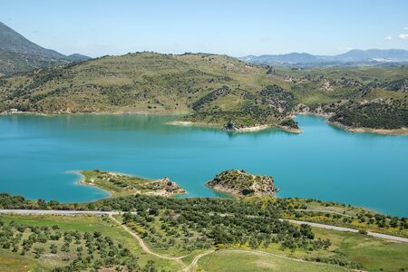 Water reservoir near Zahara de la sierra white village in Andalusia, Spainの写真素材