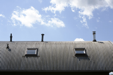 Metal roof with  windows and chimneysの写真素材