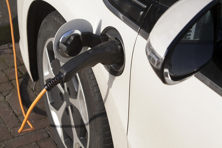 Electric Vehicle Charging in the streetの写真素材
