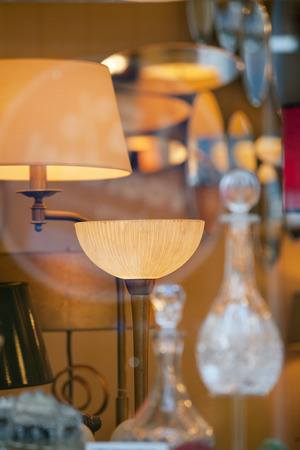Lamps, mirrors and carafes in a storeの写真素材
