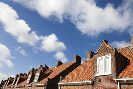 Facade of brick houses in a village street.  The houses are located in Zoeterwoude in the Netherlandsの写真素材