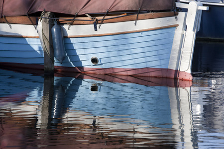 Tranquil scene of a boat and its reflectionsの写真素材