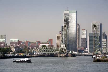 Cityscape of the south bank of the Meuse river in Rotterdam, opposite the center of town. The Hef, the old green steel rail bridge is a monument and not in use anymore.の写真素材