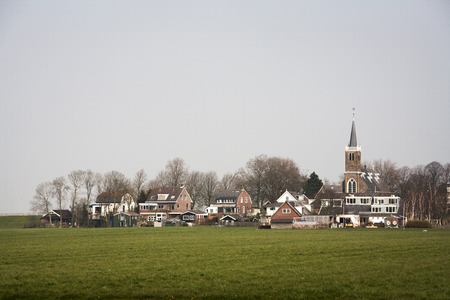 Small village with a church and some houses in the Netherlandsの写真素材