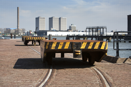 Train carriages in an industrial district near the river