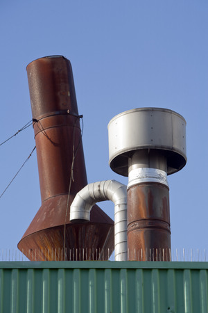 Rusted chimneys on a roof.の写真素材