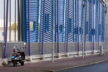 Blue metal building with a scooter parked in frontの写真素材