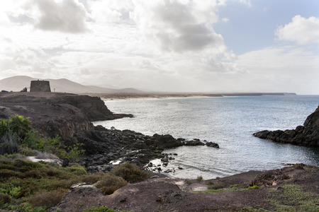Bay of El Cotillo on Fuerteventura with the tower Castillo dei Toston on the left side