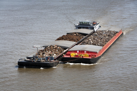 Two barges loaded with metal scrap on the riverの写真素材