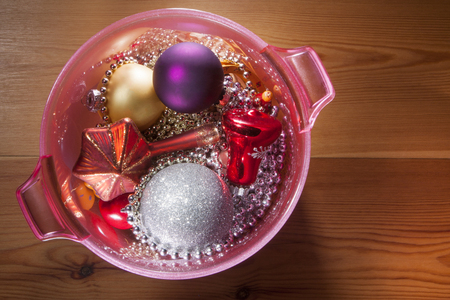 Christmas decoration in a pink champagne cooler on a wooden floorの写真素材