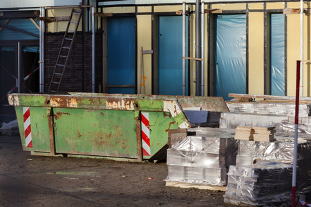 Skip and construction materials on a construction site in the Netherlandsの写真素材