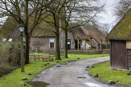 Street with historic farms and barns in Orvelte in the Netherlandsの写真素材
