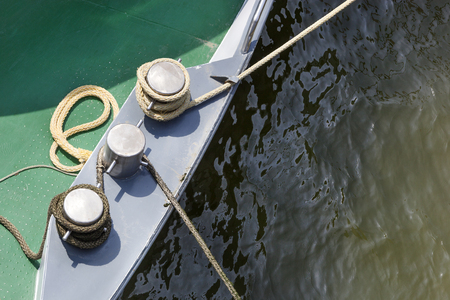 Bollards and ropes on a ship moored in harborの写真素材