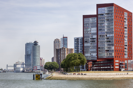 Skyline of Rotterdam Katendrecht with a passenger ship moored at the Wilhelminapier in the backgroundの写真素材