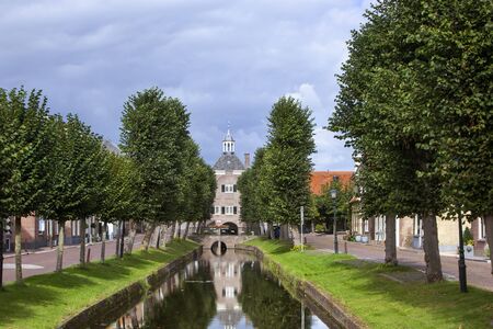 Historic city hall of Nieuwpoort between trees  in the Netherlandsの写真素材