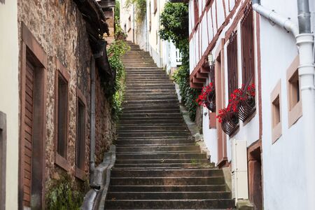 Old staircase street with idyllic houses in Niederbronn les Bains in Franceの写真素材