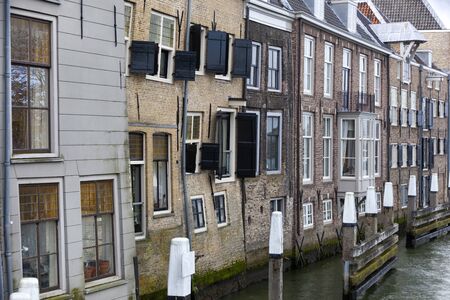Old historical crooked houses near river de Oude Maas in Dordrechtの写真素材