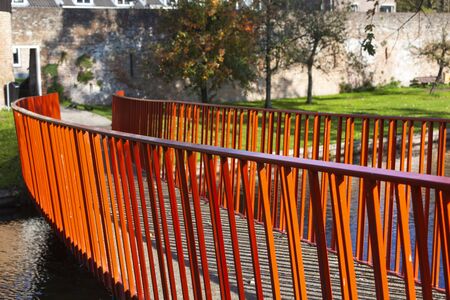 Red metal bridge connection to the old city wall in Vianen in the Netherlandsの写真素材