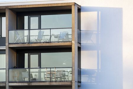 Balconies of a concrete condominium with glass railings in Rotterdam Prinsenland in the Netherlands