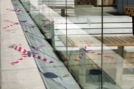 Barrier tape around the empty terraces in Rotterdam during lockdown because of the coronavirus...