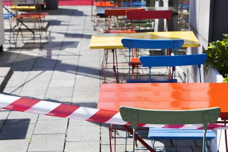 Barrier tape around the empty terraces in Rotterdam during lockdown because of the coronavirus pandemicの写真素材