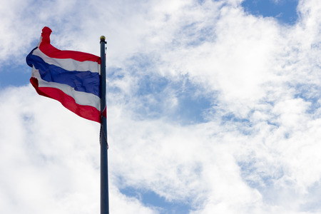 Image of waving Thai flag of Thailand with blue sky background.の写真素材