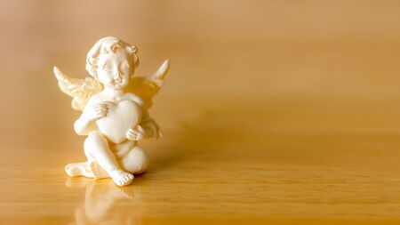 cupid cupids and hearts on wood background.の写真素材