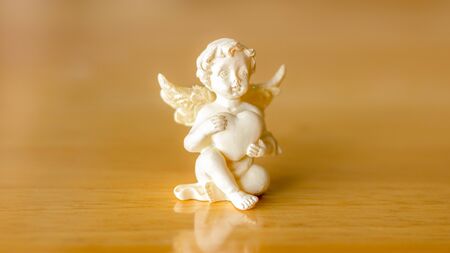 cupid cupids and hearts on wood background.の写真素材