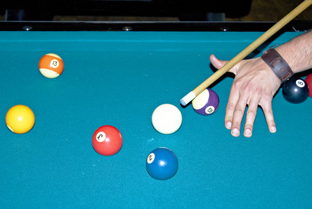 Young man playing a game of pool