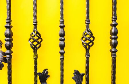 wrought iron fence ornaments on yellow background