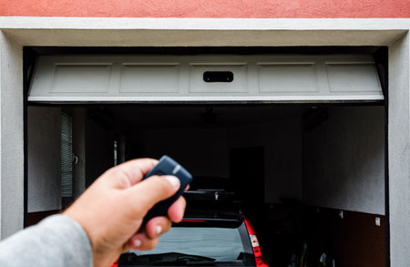 Garage door PVC. Hand use remote controller for closing and opening garage door