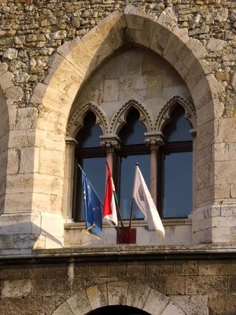 flags in a window of the Tata Castleの写真素材