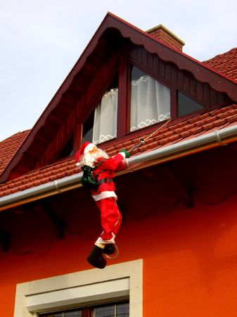 prankish Santa Claus hanging on a cavesの写真素材