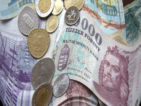 twisted paper monies with coins on them