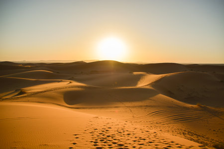 Sunset over the sand dunes of the Sahara desert in Morocco