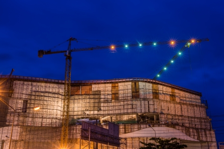 Construction site with cranes in twilight timeの写真素材