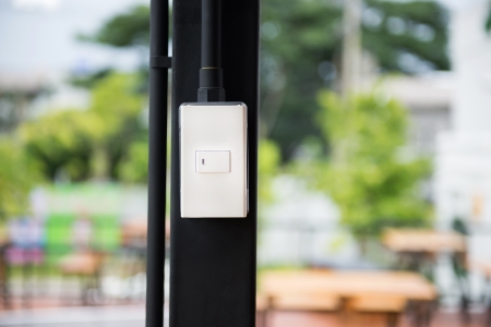 The switch of electricity with nature backgroundの写真素材